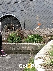 15 pictures - Dark haired girl pisses by a public car park