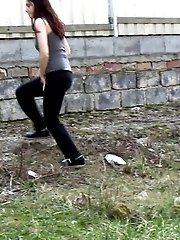 15 pictures - Gorgeous brunette filmed twice pissing outside