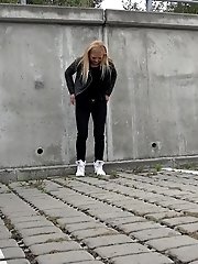 15 pictures - Sexy blonde squats outside to piss in the city