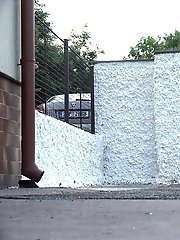 15 pictures - Blonde pisses behind a white wall outside