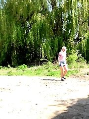 15 pictures - Blonde with tattoos sprays her piss on the ground
