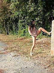 15 pictures - Raven haired babe leans on concrete to piss