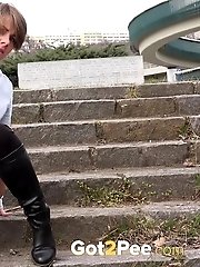 15 pictures - City pissing for cute short haired babe