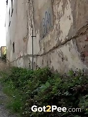 15 pictures - Pretty girl in pink dress pisses outside