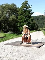 15 pictures - Sexy blonde pisses on a path in a golf course