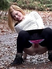 15 pictures - Playful babe nearly wets her panties outside