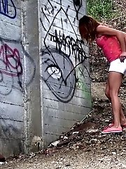 15 pictures - Pretty girl crouches on the soil to pee