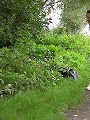 15 pictures - Cute brunette squats to piss over a woodland path