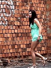 15 pictures - Brunette lifts her green dress to pee in public
