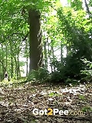 15 pictures - Sexy blonde pees in the forest