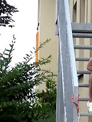 15 pictures - Sexy brunette pees on the aluminium steps
