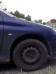 15 pictures - Dark haired babe pisses behind a parked car