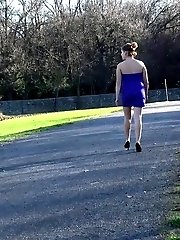 15 pictures - Brunette pees as she leans on a wall