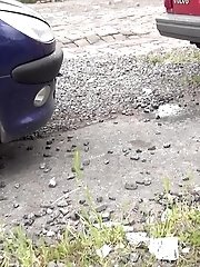 15 pictures - Dark haired babe pisses behind a parked car