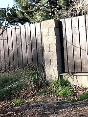 15 pictures - Brunette pees as she leans on a wall