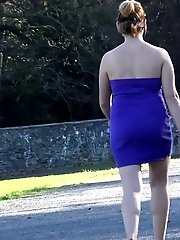 15 pictures - Brunette pees as she leans on a wall