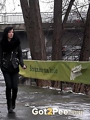 15 pictures - Pretty dark haired girl melts snow as she pees