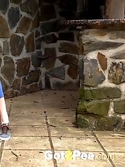 15 pictures - Brunette pulls down denims to piss outside