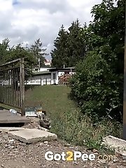 15 pictures - Dark haired European pissing outside in public