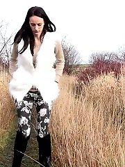 15 pictures - Dark haired babe pisses in the long grass outside