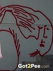 15 pictures - Sexy dark haired girl fires piss onto the concrete
