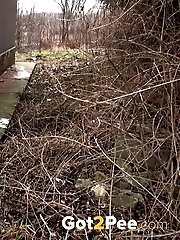 15 pictures - Brunette girl needs to pee while walking by a road
