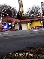 15 pictures - Brunette girl needs to pee while walking by a road