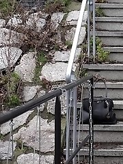 15 pictures - Sexy brunette babe pisses in public on some steps