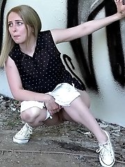 15 pictures - Blonde babe squats and pisses outside near a wall