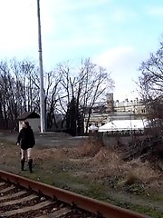 15 pictures - Brunette girl pulls down her trousers to pee outside