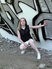 15 pictures - Blonde babe squats and pisses outside near a wall