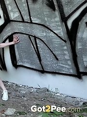 15 pictures - Blonde babe squats and pisses outside near a wall