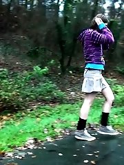 15 pictures - Brunette pisses while standing up next to a road