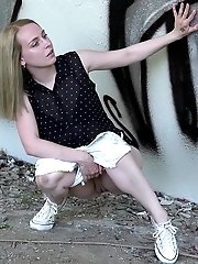 15 pictures - Blonde babe squats and pisses outside near a wall