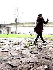 15 pictures - Cute girl in boots pisses outside in the city