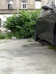 15 pictures - Dark haired girl pees next to a busy road outside