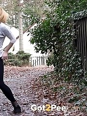 15 pictures - Playful babe nearly wets her panties outside