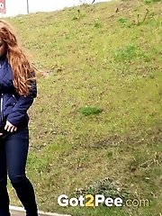 15 pictures - Redhead babe pulls down her denims to piss