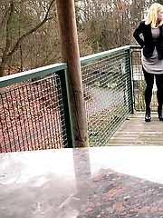 15 pictures - Blonde in pantyhose pisses on wooden decking