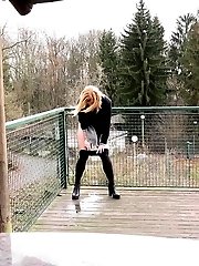 15 pictures - Blonde in pantyhose pisses on wooden decking