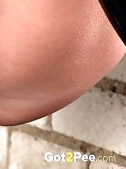 15 pictures - Cute girl in boots pisses outside in the city