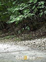 15 pictures - Bare ass is on show as a dark haired babe pees