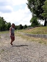 15 pictures - Pretty brunette pisses twice in this outdoor scene