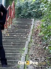 15 pictures - Pretty brunette girl pisses on the steps
