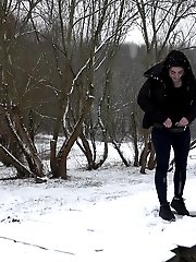 15 pictures - Dark haired girl pees on a bridge in the snow