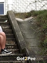 15 pictures - Cute girl in sneakers pisses on steps