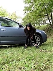 15 pictures - Exotic babe squats behind parked car to piss