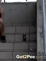 15 pictures - Cute blonde pisses in public in the city