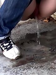 15 pictures - Cute girl in denims pisses onto the concrete