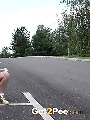 15 pictures - Tattooed blonde empties her bladder outside